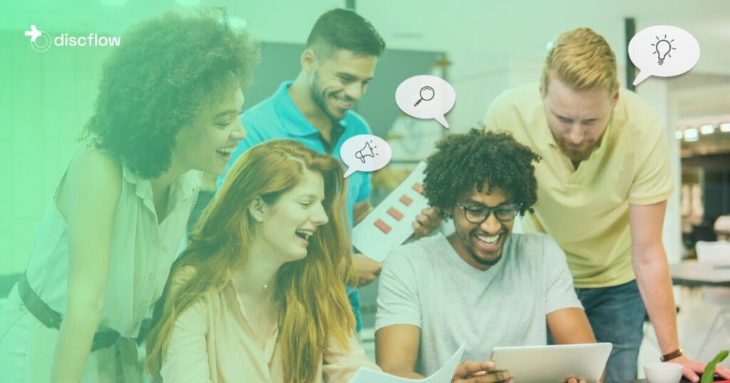 A diverse group of five people collaborates in a modern office, smiling and working together on a tablet and documents, with the Discflow logo in the top left corner and speech bubbles containing icons of a lightbulb, magnifying glass, and megaphone, symbolizing ideas, analysis, and communication, against a light green background.